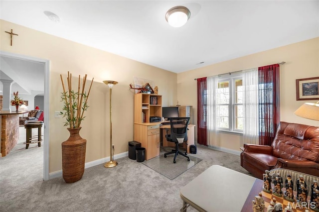 home office featuring light carpet and baseboards