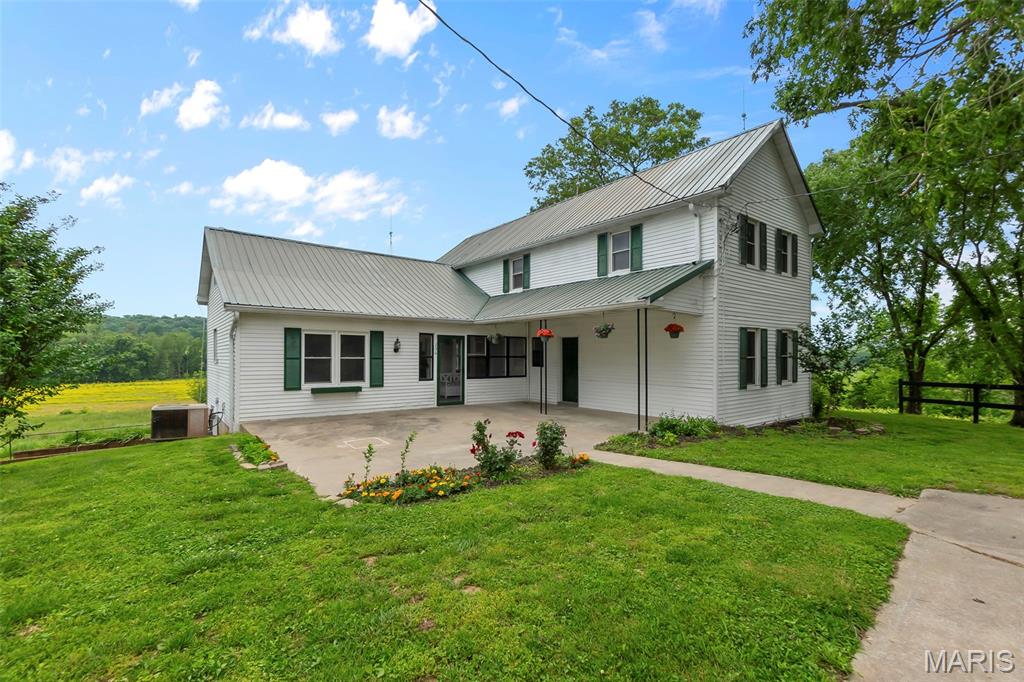 236 Borax Ln, Cape Girardeau, MO 63701 - view of front of house with metal roof, central AC unit, and a patio area