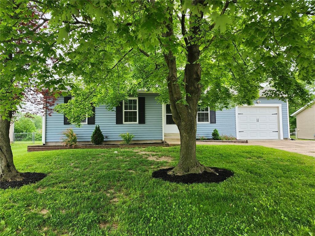 1908 Winter Hill Dr, Ofallon, MO 63366 - obstructed view of property featuring driveway, a front yard, and an attached garage