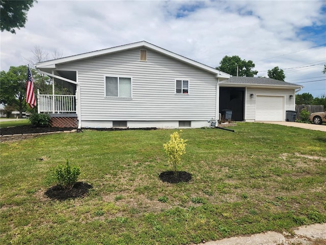 1104 Ringo St, Mexico, MO 65265 - view of side of property with an attached garage, a lawn, and driveway