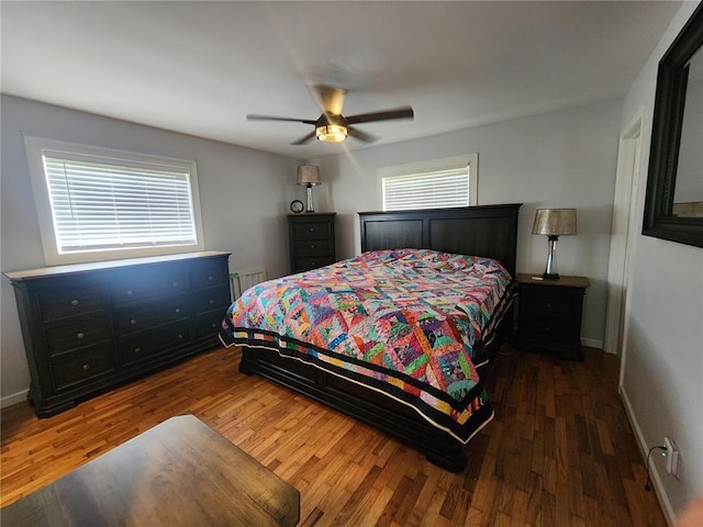 1104 Ringo St, Mexico, MO 65265 - bedroom featuring baseboards, radiator, wood finished floors, and ceiling fan