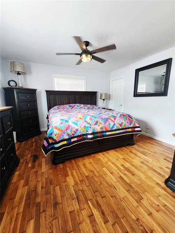 1104 Ringo St, Mexico, MO 65265 - bedroom with wood finished floors, ceiling fan, and baseboards