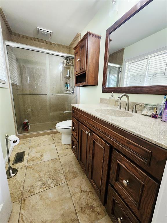 1104 Ringo St, Mexico, MO 65265 - bathroom with toilet, a stall shower, and vanity