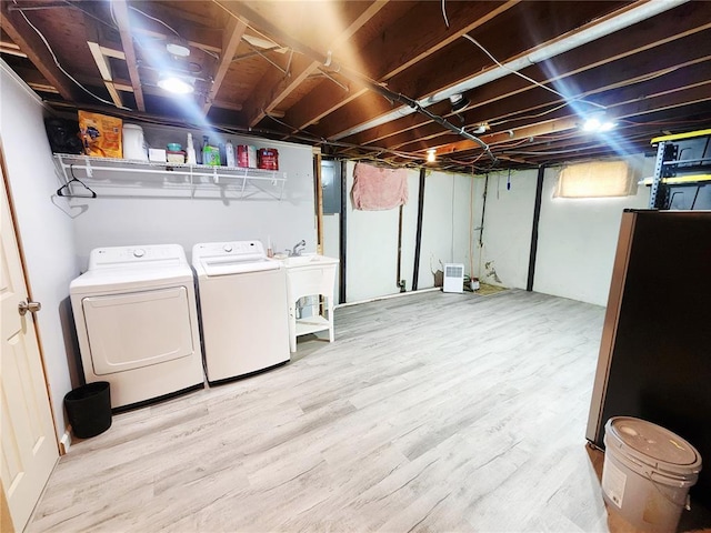 1104 Ringo St, Mexico, MO 65265 - washroom featuring washer and dryer and wood finished floors