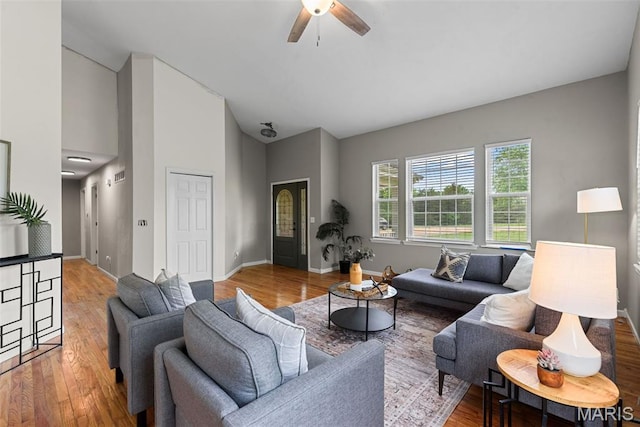 122 Morgan Lake Rd, De Soto, MO 63020 - living area featuring a ceiling fan, high vaulted ceiling, wood finished floors, and baseboards
