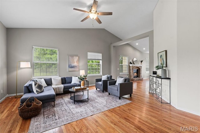 122 Morgan Lake Rd, De Soto, MO 63020 - living area with wood finished floors, lofted ceiling, a ceiling fan, baseboards, and a glass covered fireplace