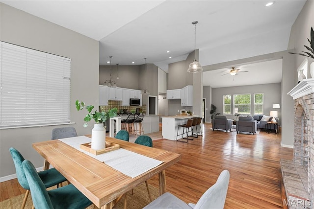 122 Morgan Lake Rd, De Soto, MO 63020 - dining room featuring light wood finished floors, a ceiling fan, recessed lighting, a fireplace, and baseboards