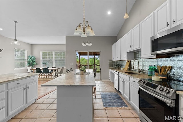 122 Morgan Lake Rd, De Soto, MO 63020 - kitchen featuring stainless steel appliances, a sink, a kitchen island, decorative backsplash, and a chandelier