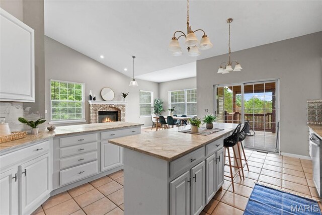 122 Morgan Lake Rd, De Soto, MO 63020 - kitchen with a chandelier, healthy amount of natural light, light tile patterned flooring, vaulted ceiling, and recessed lighting