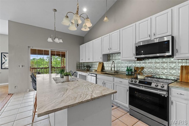 122 Morgan Lake Rd, De Soto, MO 63020 - kitchen with stainless steel appliances, a sink, a chandelier, backsplash, and light tile patterned floors