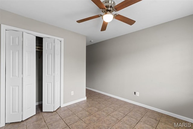 122 Morgan Lake Rd, De Soto, MO 63020 - unfurnished bedroom featuring a closet, baseboards, light tile patterned floors, and ceiling fan