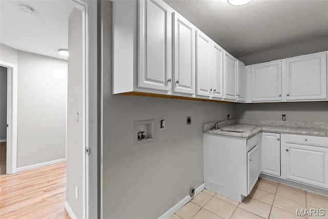 122 Morgan Lake Rd, De Soto, MO 63020 - laundry room with cabinet space, washer hookup, hookup for an electric dryer, baseboards, and light tile patterned floors
