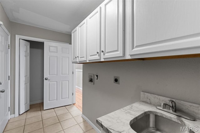 122 Morgan Lake Rd, De Soto, MO 63020 - laundry room featuring cabinet space, electric dryer hookup, washer hookup, light tile patterned floors, and baseboards