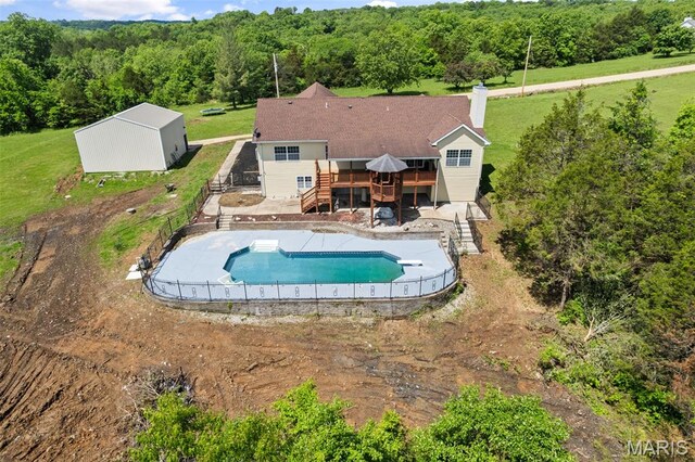 122 Morgan Lake Rd, De Soto, MO 63020 - swimming pool featuring stairway, a deck, and a forest view