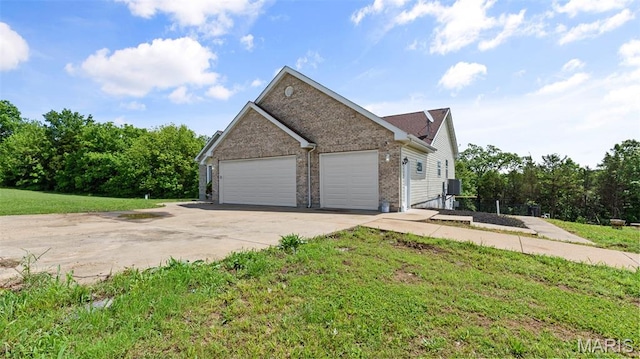 122 Morgan Lake Rd, De Soto, MO 63020 - view of home's exterior with a garage, driveway, brick siding, and a lawn
