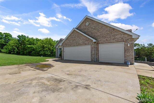 122 Morgan Lake Rd, De Soto, MO 63020 - view of side of property with brick siding, a yard, and concrete driveway