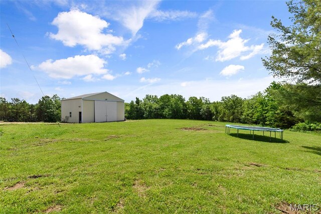 122 Morgan Lake Rd, De Soto, MO 63020 - view of grassy yard featuring a trampoline and an outbuilding