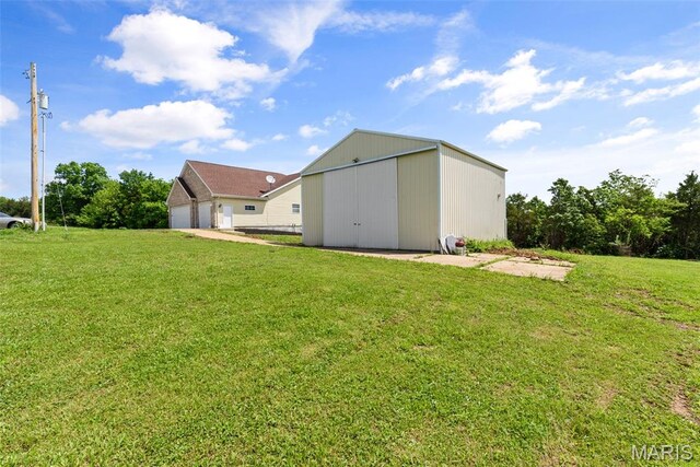 122 Morgan Lake Rd, De Soto, MO 63020 - view of grassy yard with an outdoor structure, a garage, and an outbuilding
