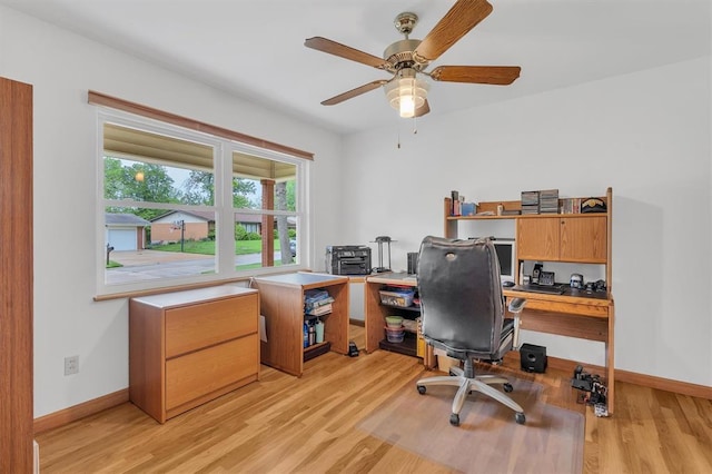 office space featuring light wood-style flooring, baseboards, and ceiling fan