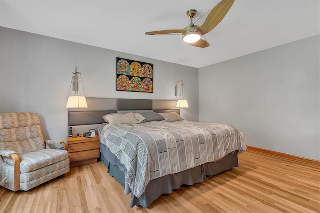bedroom with light wood-style flooring, ceiling fan, and baseboards