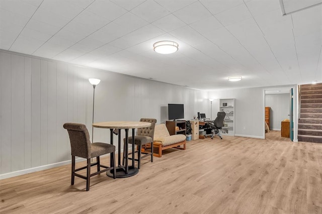 living area featuring wood finished floors, stairway, an office area, and baseboards