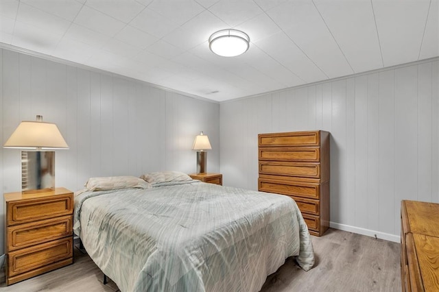 bedroom featuring light wood-style flooring and baseboards