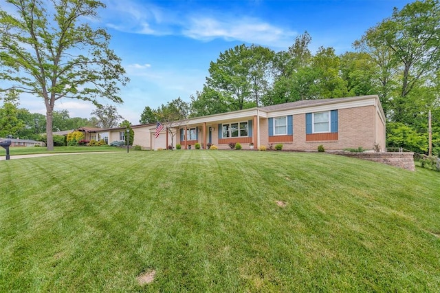 single story home with a front yard and brick siding
