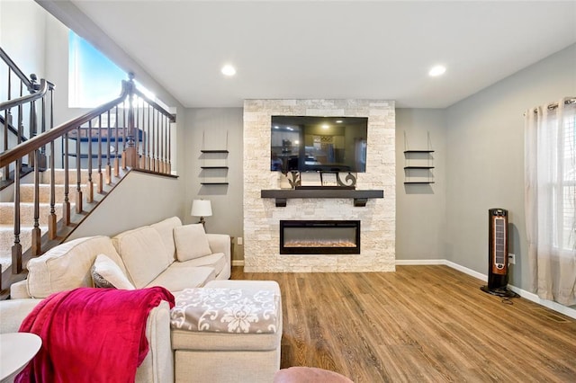 491 Cypress Creek Ln, Imperial, MO 63052 - living area with wood finished floors, baseboards, stairs, plenty of natural light, and recessed lighting