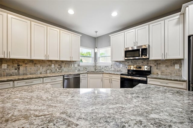 491 Cypress Creek Ln, Imperial, MO 63052 - kitchen with appliances with stainless steel finishes, a sink, recessed lighting, decorative backsplash, and light stone counters