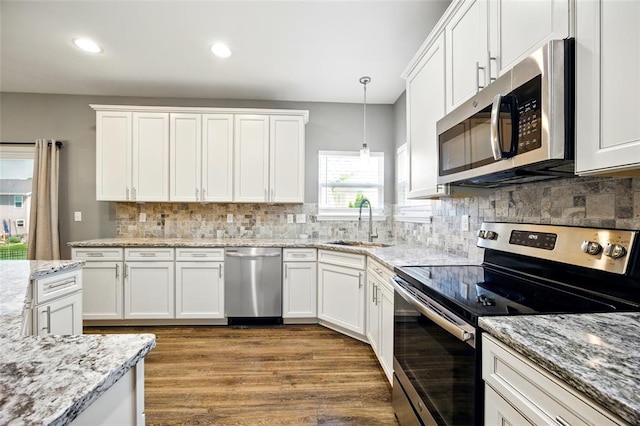 491 Cypress Creek Ln, Imperial, MO 63052 - kitchen featuring appliances with stainless steel finishes, a sink, white cabinets, wood finished floors, and decorative backsplash