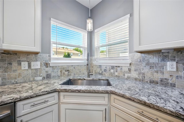 491 Cypress Creek Ln, Imperial, MO 63052 - kitchen featuring a sink, white cabinetry, decorative backsplash, pendant lighting, and light stone counters