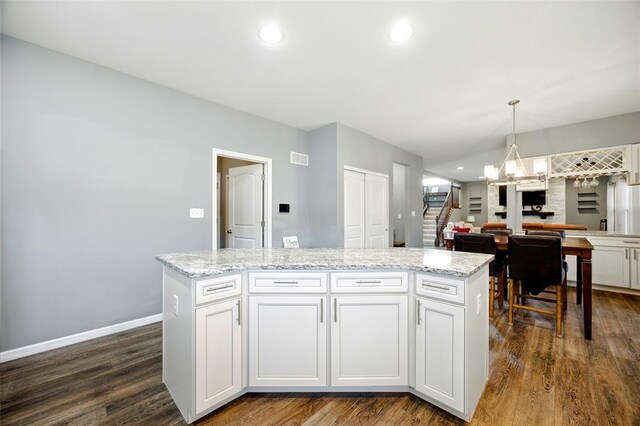 491 Cypress Creek Ln, Imperial, MO 63052 - kitchen with a chandelier, dark wood-type flooring, a center island, light stone countertops, and recessed lighting