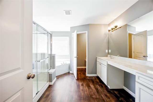 491 Cypress Creek Ln, Imperial, MO 63052 - bathroom featuring vanity, wood finished floors, a stall shower, a bath, and baseboards