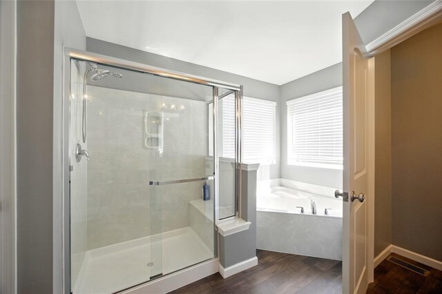 491 Cypress Creek Ln, Imperial, MO 63052 - bathroom with wood finished floors, a bath, a stall shower, and baseboards