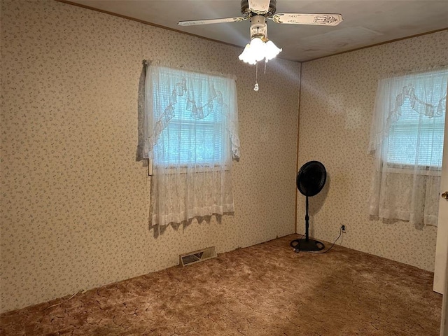 16864 State Highway 32, Bismarck, MO 63624 - empty room featuring carpet flooring, crown molding, healthy amount of natural light, a ceiling fan, and wallpapered walls