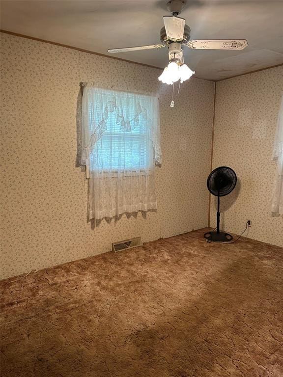 16864 State Highway 32, Bismarck, MO 63624 - empty room with carpet, a ceiling fan, wallpapered walls, and ornamental molding