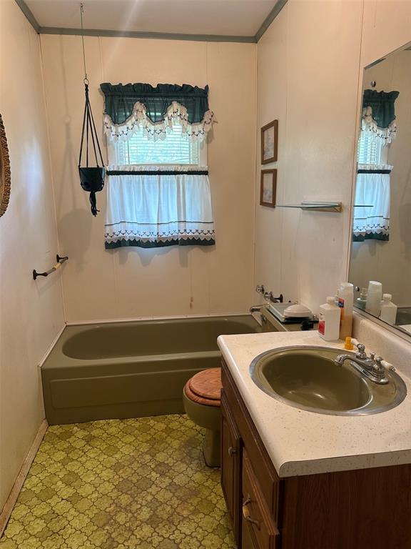 16864 State Highway 32, Bismarck, MO 63624 - full bath featuring tile patterned floors, toilet, and vanity