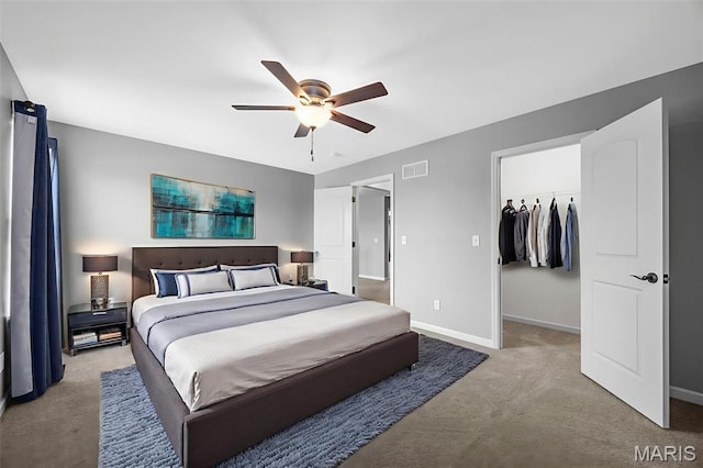 137 Countryshire Dr, Lake St Louis, MO 63367 - carpeted bedroom featuring a walk in closet, baseboards, and ceiling fan