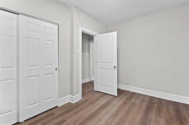 5039 Grace Ave, Saint Louis, MO 63116 - unfurnished bedroom featuring wood finished floors and baseboards