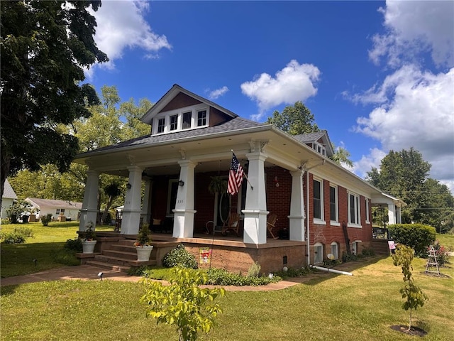339 E Reynolds St E, Ironton, MO 63650 - greek revival inspired property with covered porch, a front yard, brick siding, and roof with shingles
