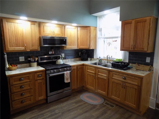 339 E Reynolds St E, Ironton, MO 63650 - kitchen featuring appliances with stainless steel finishes, a sink, light countertops, decorative backsplash, and dark wood-style floors