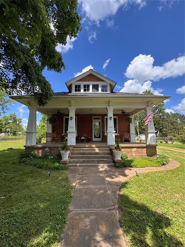 339 E Reynolds St E, Ironton, MO 63650 - view of front facade featuring a porch, a front lawn, and brick siding