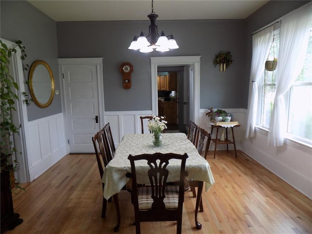 339 E Reynolds St E, Ironton, MO 63650 - dining space featuring a chandelier, wainscoting, light wood finished floors, and a decorative wall