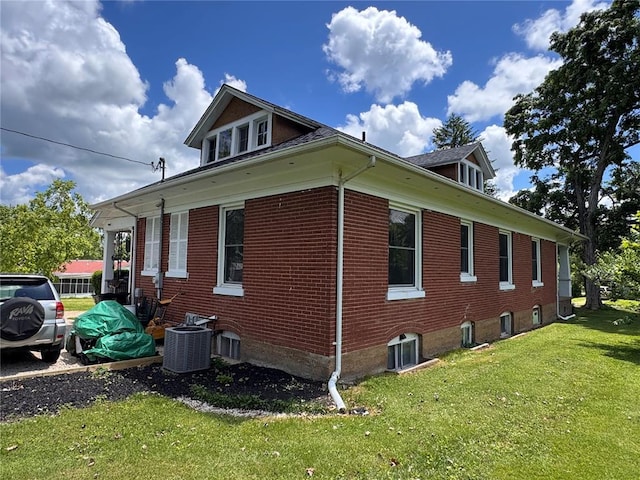 339 E Reynolds St E, Ironton, MO 63650 - view of side of property with central AC unit, a lawn, and brick siding