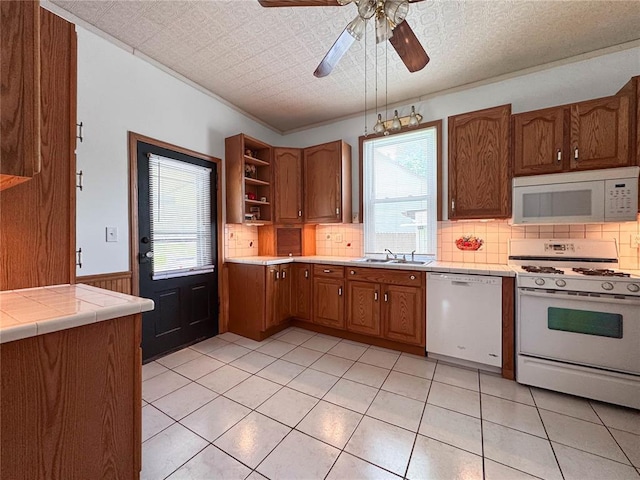 kitchen featuring white appliances, a sink, open shelves, decorative backsplash, and a ceiling fan