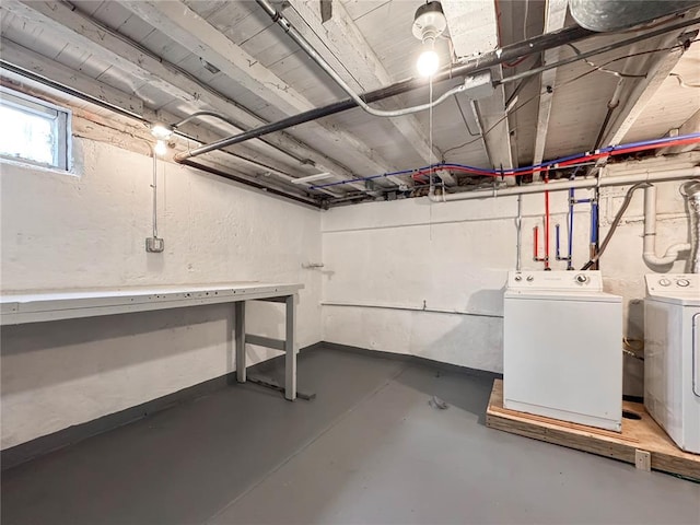 basement with separate washer and dryer and a textured wall