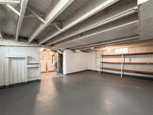 unfinished below grade area with heating unit and washer / dryer