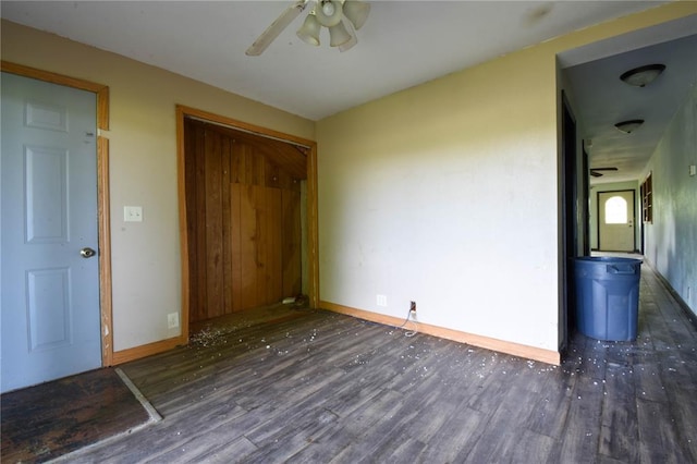 880 W Nicholas St, Carlinville, IL 62626 - unfurnished bedroom with wood finished floors, baseboards, ceiling fan, and a closet