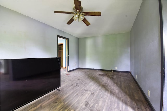 880 W Nicholas St, Carlinville, IL 62626 - unfurnished room with wood finished floors, a ceiling fan, and baseboards