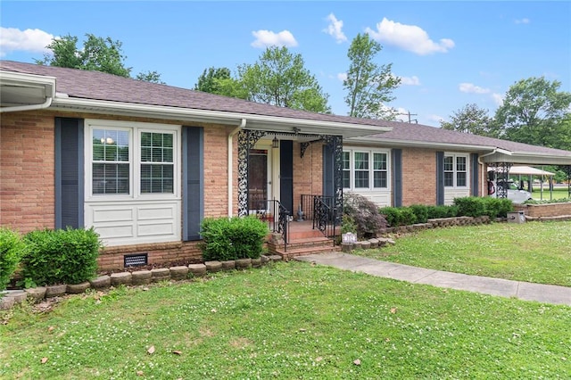102 E Charlotte, Lilbourn, MO 63862 - single story home featuring a front yard, brick siding, a porch, and roof with shingles